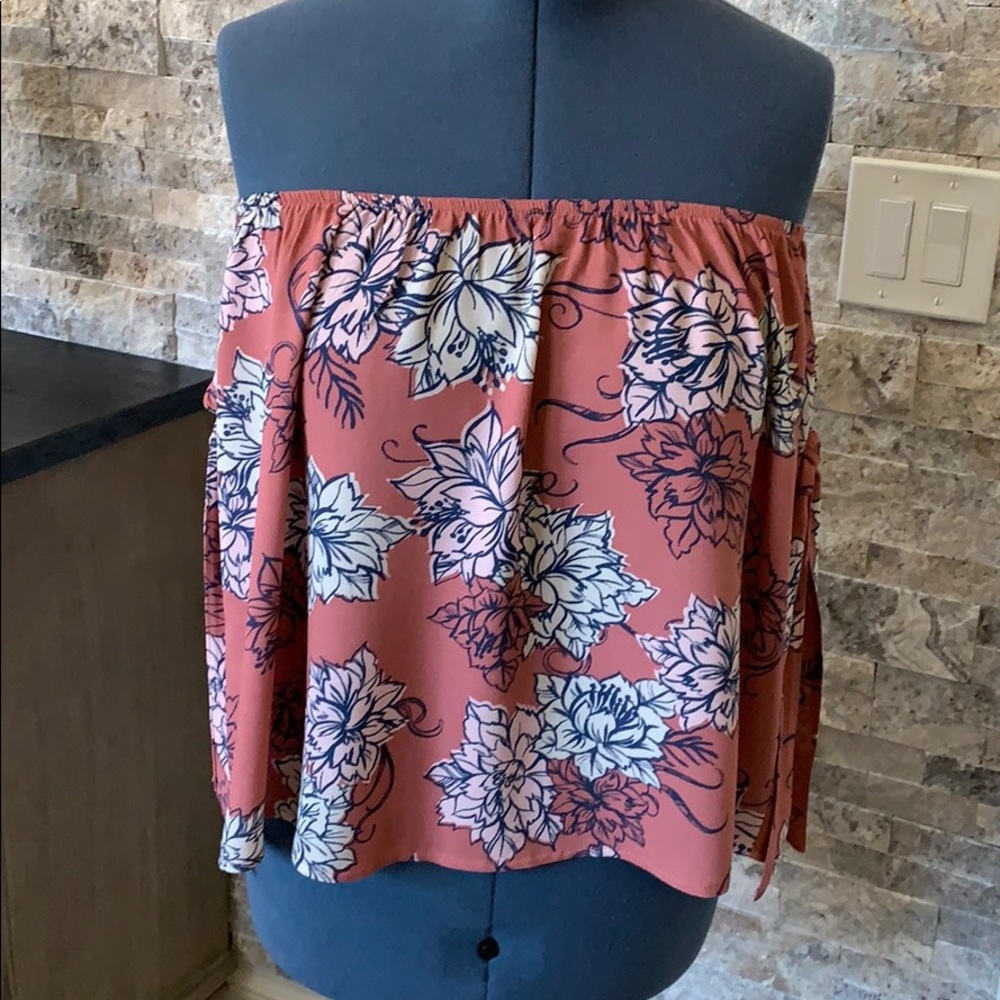 Sleeveless top with ribbon tied sleeves.